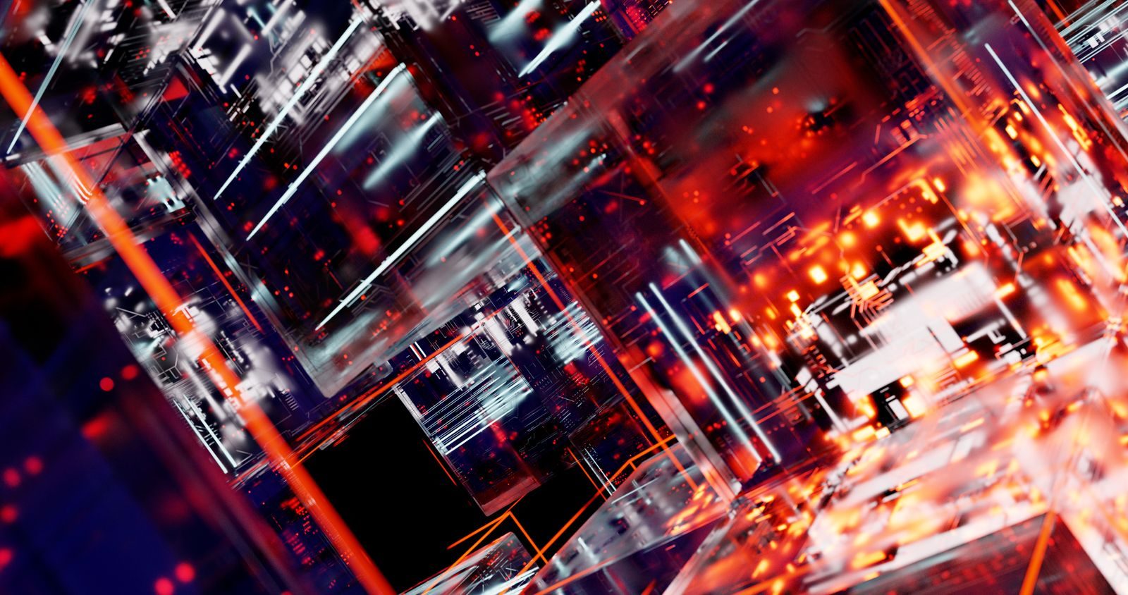 Escritório de tecnologia com profissionais diante de telas de computador