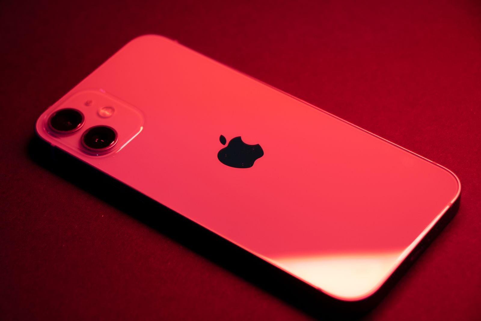 Mão segurando um iPhone com alerta de segurança na tela