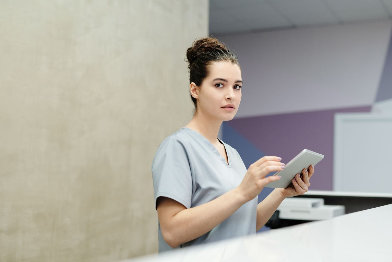 Profissional de saúde usando sistema digital de agendamento em hospital